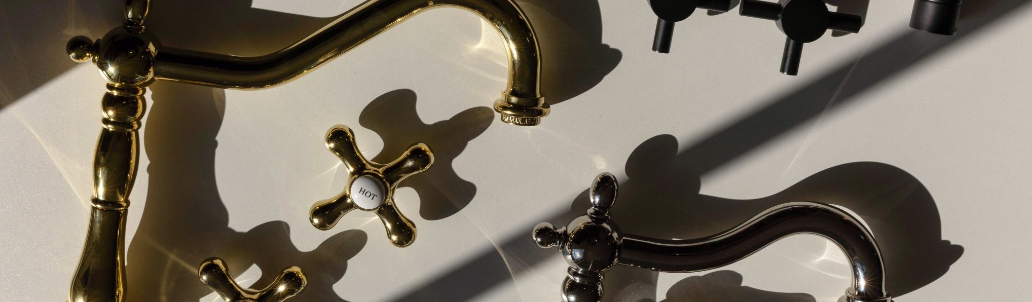 a variety of bar and cocktail items like a silver shaker, fluted champagne glasses, stirring utensils, bottle, towel, lemon, and decor accessories