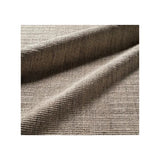 A close-up of textured woven area rug in a warm taupe-beige color, shown with soft folds and ribbed texture on a white background.