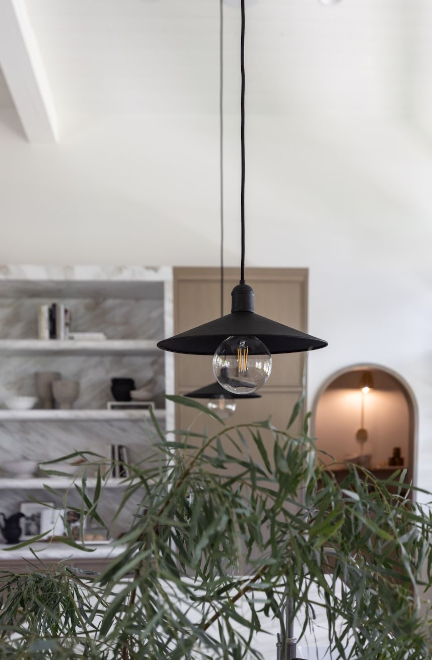 Mccoy pendants with shelves in the background and greenery in the foreground