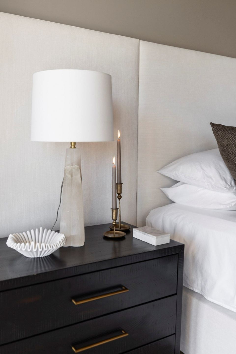 Modern bedroom with a Regina Andrew Quatrefoil Alabaster Table Lamp on a nightstand beside a bed.