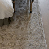Willa patterned power loomed area rug on a wooden floor with a bed and bench in the background