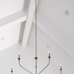 nottaway large modern chandelier hanging from a high white ceiling with beams