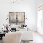 Modern living room with nottaway  large modern chandelier white sofa, beige chair, artwork, rug and decorative elements