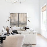 Modern living room with nottaway  large modern chandelier white sofa, beige chair, artwork, rug and decorative elements