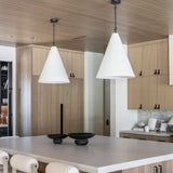 Modern kitchen with wooden cabinets, white countertops, and Grazia pendant lights over kitchen island.