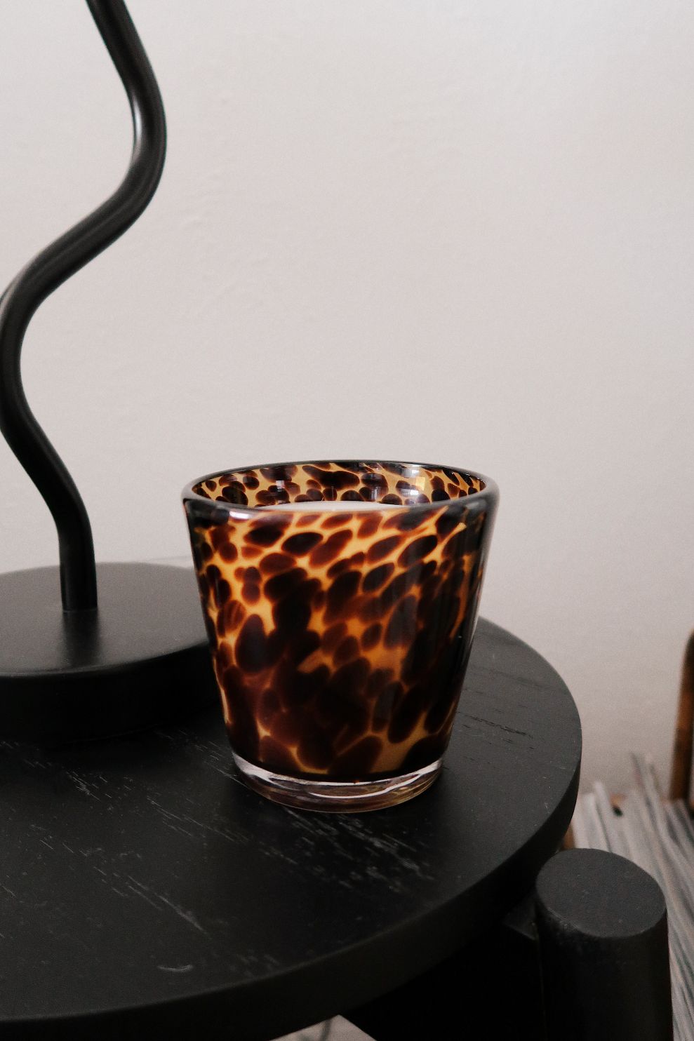 Rare tortoise print candle holder on a black surface with a white background